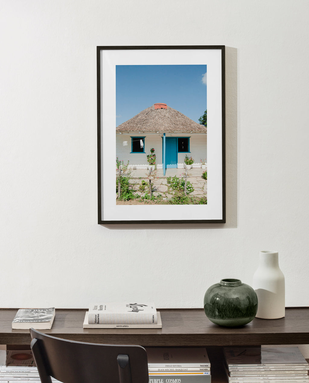 Quadro paesaggistico con casetta e porta blu